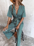 CHICMY- Plunging Neck Allover Floral Print Belted Jumpsuit