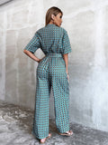 CHICMY- Plunging Neck Allover Floral Print Belted Jumpsuit